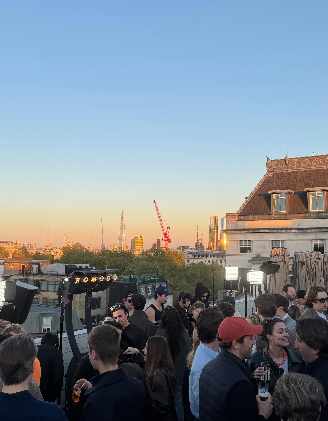 A rooftop gathering at sunset